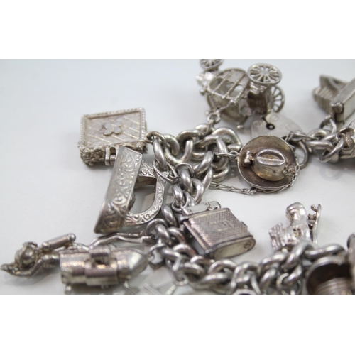 2348 - A silver charm bracelet with assorted charms - approx. gross weight 103g