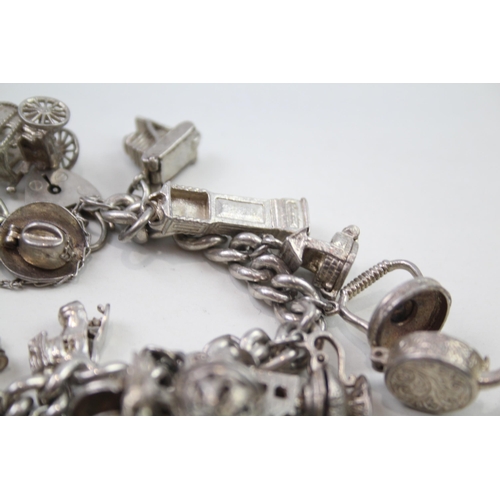 2348 - A silver charm bracelet with assorted charms - approx. gross weight 103g