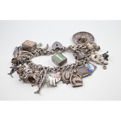 2349 - A silver charm bracelet with assorted charms - approx. gross weight 69g