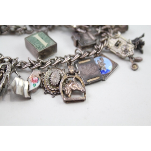 2349 - A silver charm bracelet with assorted charms - approx. gross weight 69g