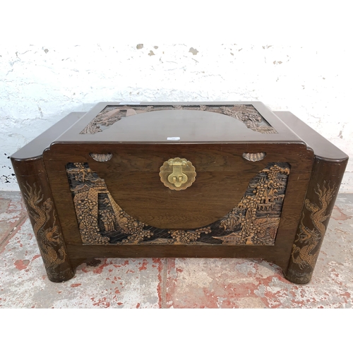 104 - A Chinese carved camphor wood blanket box - approx. 56cm high x 101cm wide x 56cm deep