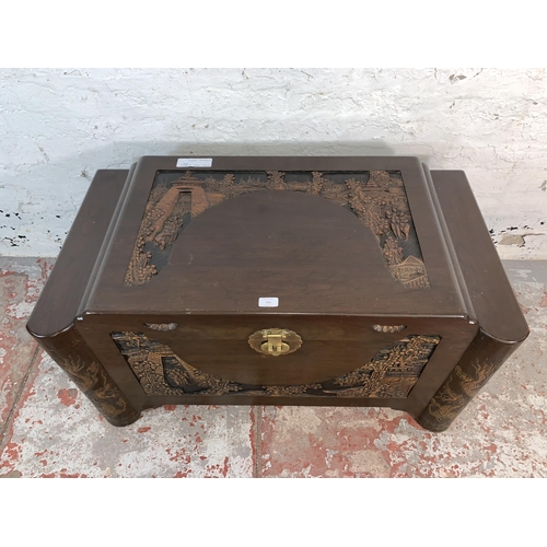 104 - A Chinese carved camphor wood blanket box - approx. 56cm high x 101cm wide x 56cm deep