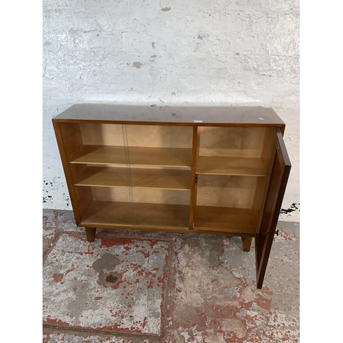 107 - A mid 20th century Lebus oak bookcase with two glass sliding doors - approx. 80cm high x 107cm wide ... 