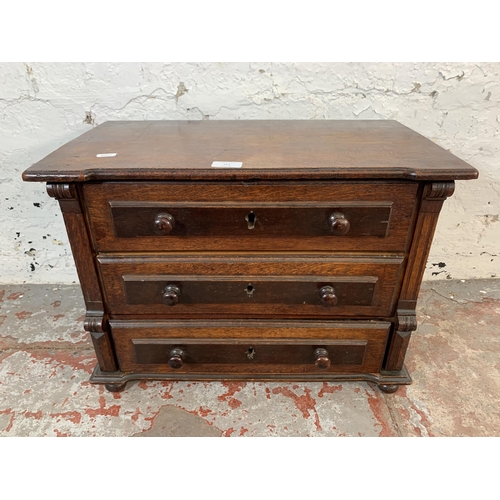 221 - A late 19th/early 20th century carved oak miniature chest of drawers - approx. 41cm high x 56cm wide... 