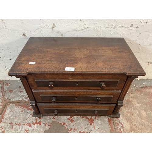 221 - A late 19th/early 20th century carved oak miniature chest of drawers - approx. 41cm high x 56cm wide... 