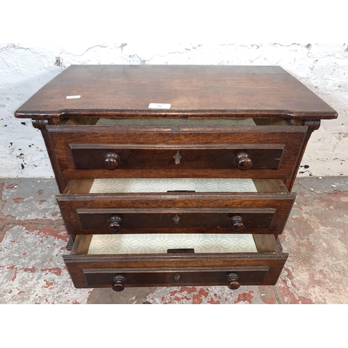 221 - A late 19th/early 20th century carved oak miniature chest of drawers - approx. 41cm high x 56cm wide... 