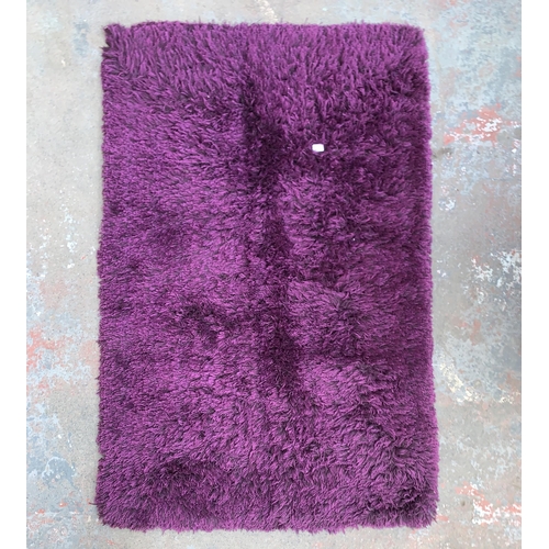 233 - An Oriental Carpets & Rugs Monte Carlo purple rug - approx. 170cm x 110cm