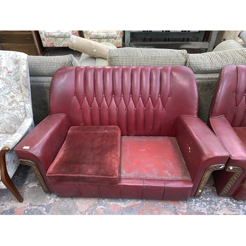 241 - An Art Deco red vinyl and carved wooden three piece lounge suite comprising two seater sofa and two ... 