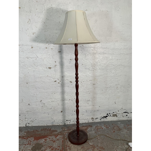 69B - A mahogany standard lamp - approx. 169cm high including shade