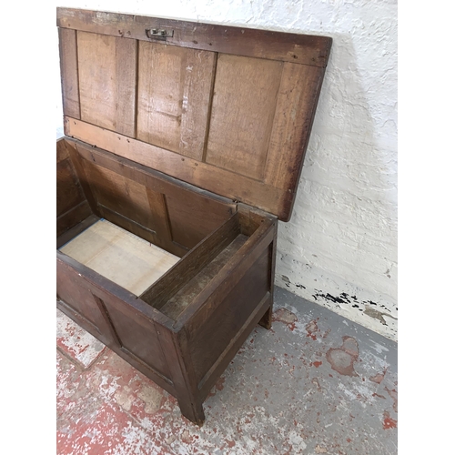 76 - A Georgian oak three panel coffer - approx. 66cm high x 121cm wide x 54cm deep