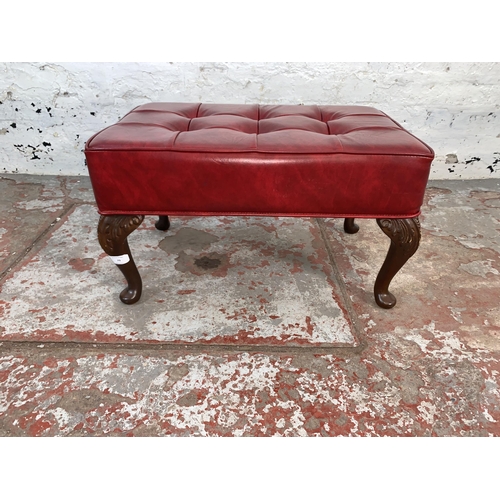 79 - A mid 20th century Sherborne red vinyl upholstered footstool on cabriole supports - approx. 32cm hig... 