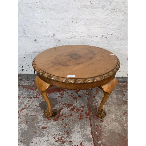 82 - A Georgian style walnut circular occasional table on ball and claw supports - approx. 40cm high x 61... 