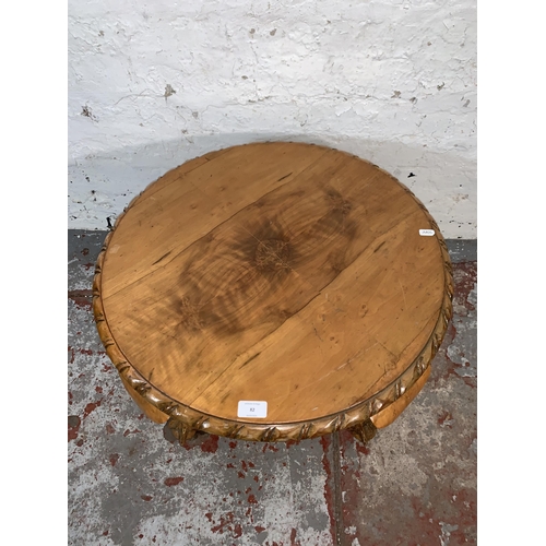 82 - A Georgian style walnut circular occasional table on ball and claw supports - approx. 40cm high x 61... 