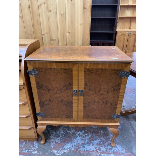 87 - A burr walnut effect two door TV cabinet on cabriole supports