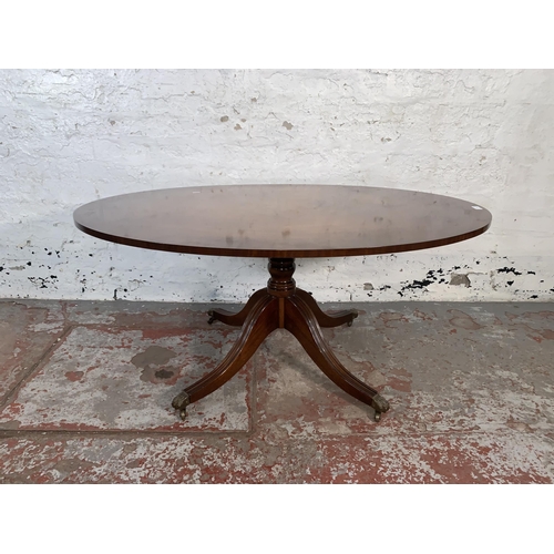 90 - A Regency style mahogany oval pedestal coffee table - approx. 55cm high x 84cm wide x 122cm long