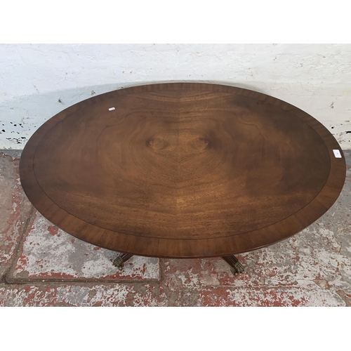 90 - A Regency style mahogany oval pedestal coffee table - approx. 55cm high x 84cm wide x 122cm long