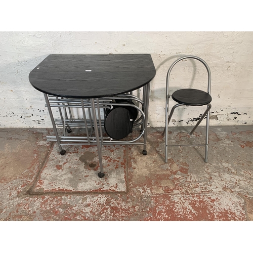 93 - A modern black ash effect drop leaf space saving dining table and four chairs