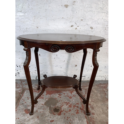 99 - An Edwardian carved mahogany oval two tier side table - approx. 72cm high x 50cm wide x 77cm long