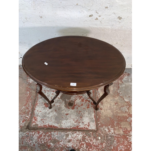 99 - An Edwardian carved mahogany oval two tier side table - approx. 72cm high x 50cm wide x 77cm long