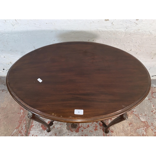 99 - An Edwardian carved mahogany oval two tier side table - approx. 72cm high x 50cm wide x 77cm long