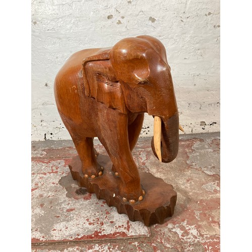 209 - A carved teak elephant statue - approx. 70cm high x 21cm wide x 58cm long