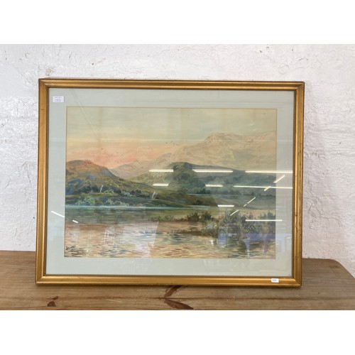 250B - A gilt framed watercolour of a landscape scene, signed lower left - approx. 72cm high x 92cm wide