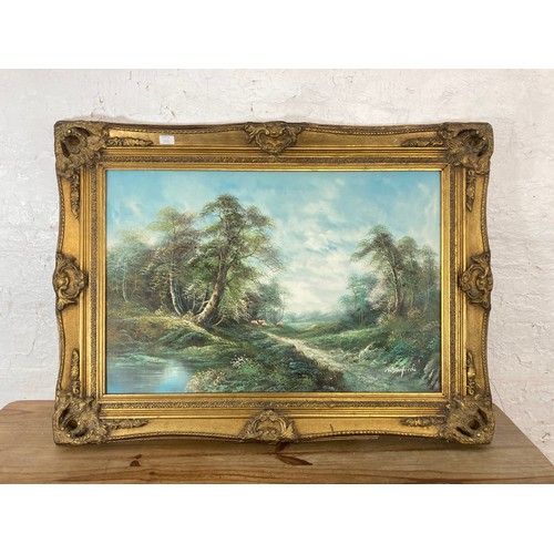 250C - A gilt framed oil on board of a countryside scene, signed R. Danford - approx. 87cm high x 116cm wid... 