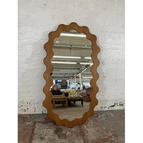 255 - An Urban Outfitters Sofia cherry wood framed wall mirror - approx. 165cm high x 89cm wide