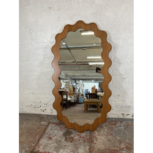 255 - An Urban Outfitters Sofia cherry wood framed wall mirror - approx. 165cm high x 89cm wide