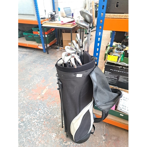 1168 - A golf bag containing a collection of golf clubs to include PMG 2 Tour Series, Apollo Seamless etc.