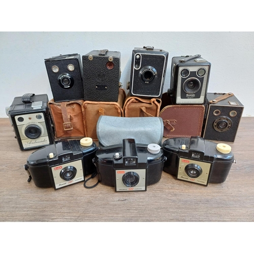 306 - Nine box cameras to include Coronet Ambassador, three Kodak Brownie 127 etc.