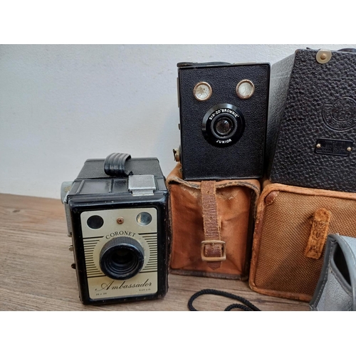 306 - Nine box cameras to include Coronet Ambassador, three Kodak Brownie 127 etc.