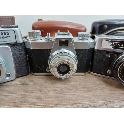 308 - Seven vintage cameras to include Halina PET, two Ilford Sportsman, Dacora Digna etc.