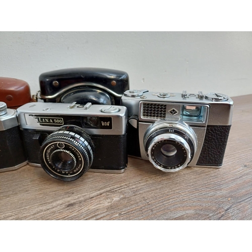 308 - Seven vintage cameras to include Halina PET, two Ilford Sportsman, Dacora Digna etc.