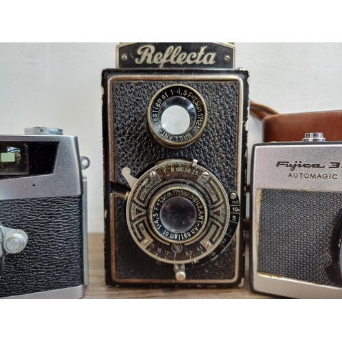 309 - Four vintage cameras, one Richter Reflecta 6x6 TLR, one cased Fujica 35 Automagic, one Petri 7s 35mm... 