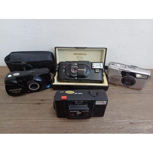 323 - Four Olympus compact 35mm cameras, one cased XA fitted with A11 flash, one µ[mju:]-II Zoom 115, one ... 