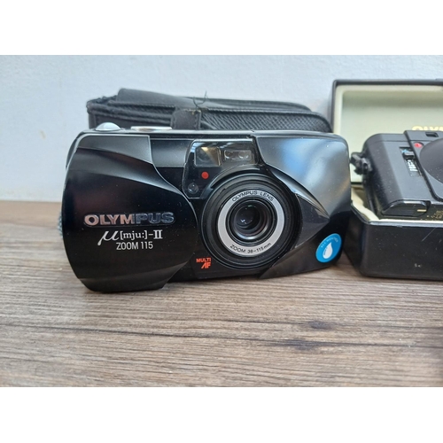 323 - Four Olympus compact 35mm cameras, one cased XA fitted with A11 flash, one µ[mju:]-II Zoom 115, one ... 