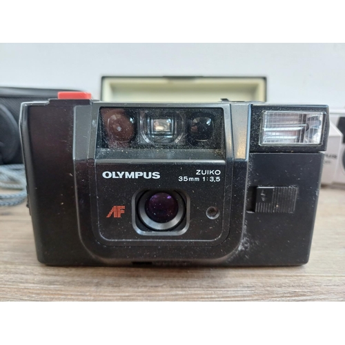 323 - Four Olympus compact 35mm cameras, one cased XA fitted with A11 flash, one µ[mju:]-II Zoom 115, one ... 