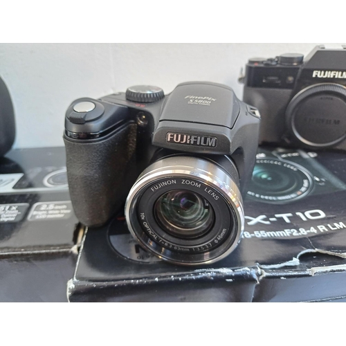 327 - Two boxed Fujifilm digital cameras, one X-T10 16mp with instruction manual and charger and one cased... 