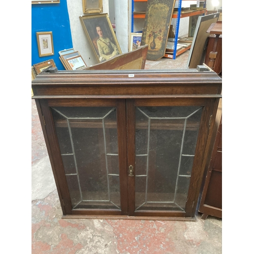 10 - Two pieces of furniture, one early 20th century oak bookcase top with two leaded glass doors and one... 