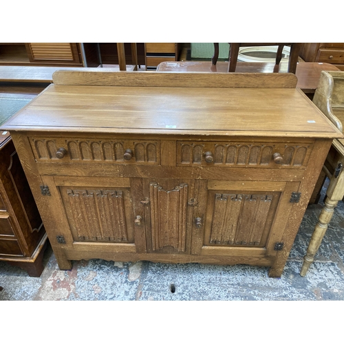 113 - An L. Marcus Ltd. carved oak linenfold sideboard - approx. 93cm high x 122cm wide x 48cm deep