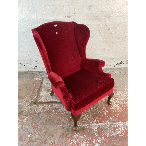 126 - A mid 20th century Parker Knoll PK976 red fabric upholstered wingback armchair on cabriole supports