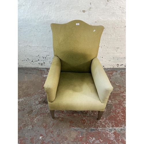 127 - An early/mid 20th century green fabric upholstered armchair