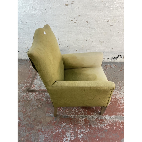 127 - An early/mid 20th century green fabric upholstered armchair