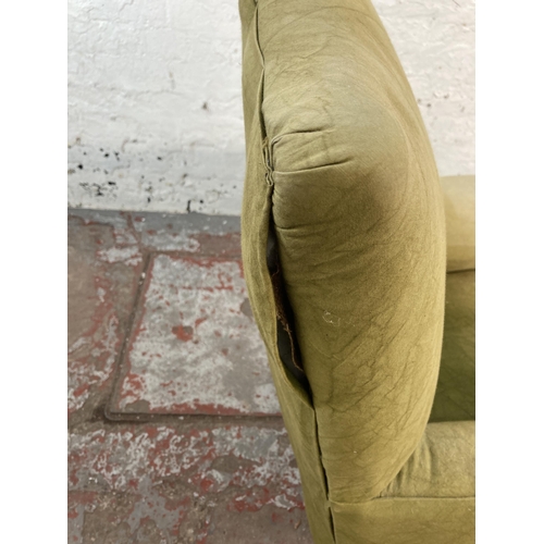 127 - An early/mid 20th century green fabric upholstered armchair