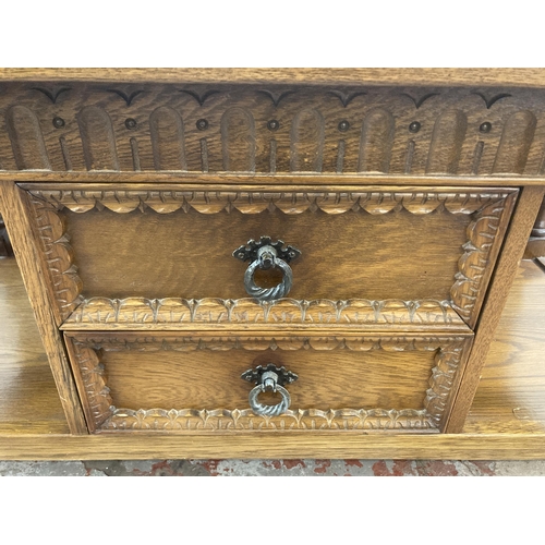 13 - A carved oak rectangular two tier coffee table - approx. 46cm high x 48cm wide x 101cm long