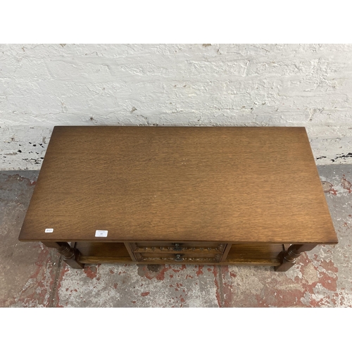 13 - A carved oak rectangular two tier coffee table - approx. 46cm high x 48cm wide x 101cm long