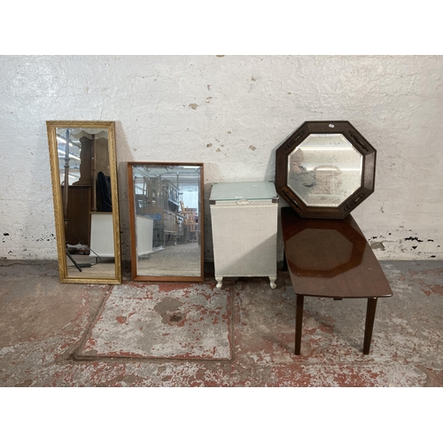 131 - Five items, three framed wall mirrors, one Lloyd Loom wicker laundry basket and one mid 20th century... 