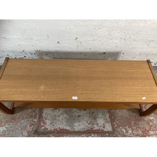 143 - A mid 20th century teak rectangular two tier coffee table - approx. 42cm high x 44cm wide x 134cm lo... 