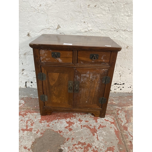 147 - An Oriental elm miniature cabinet - approx. 42cm high x 39.5cm wide x 25cm deep